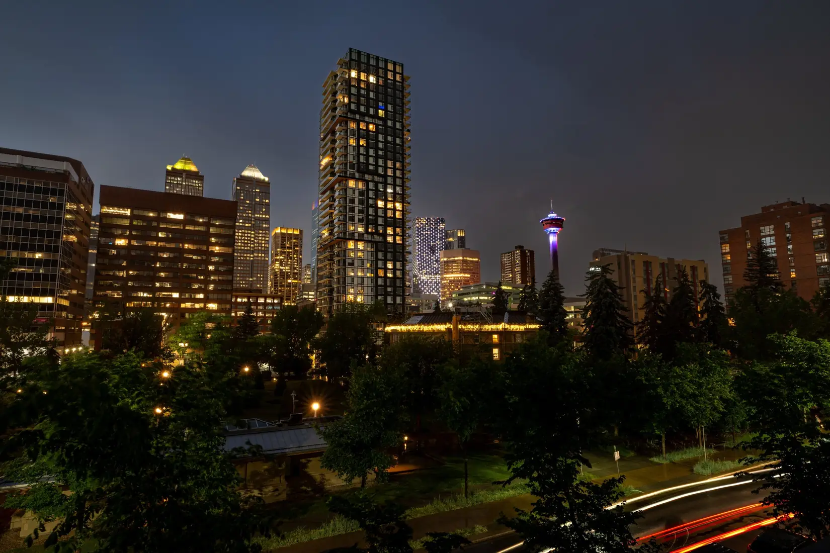 Calgary skyline and the Calgary Tower at night, with traffic light trails